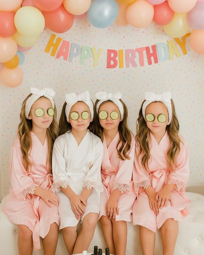 Girls in spa robes with cucumber slices